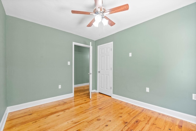 spare room featuring hardwood / wood-style floors and ceiling fan