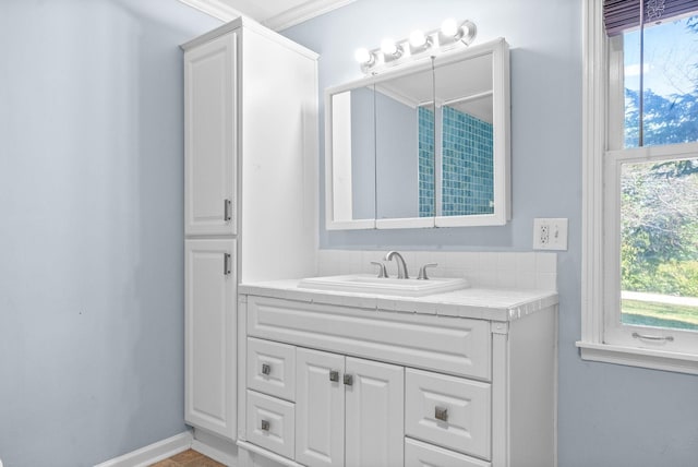 bathroom with vanity and ornamental molding