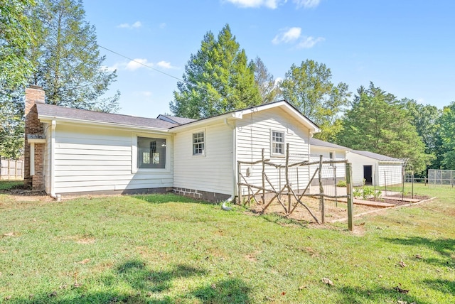 rear view of house with a yard