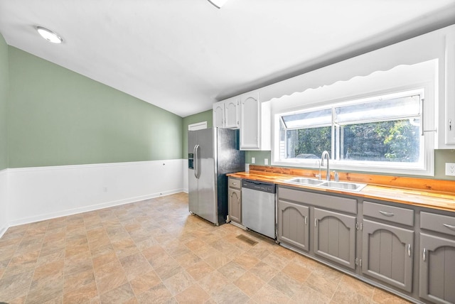 kitchen with wooden counters, appliances with stainless steel finishes, gray cabinetry, and sink