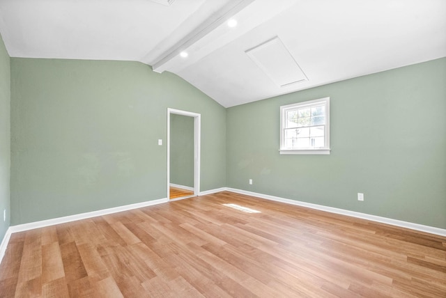 empty room featuring light hardwood / wood-style flooring and lofted ceiling with beams