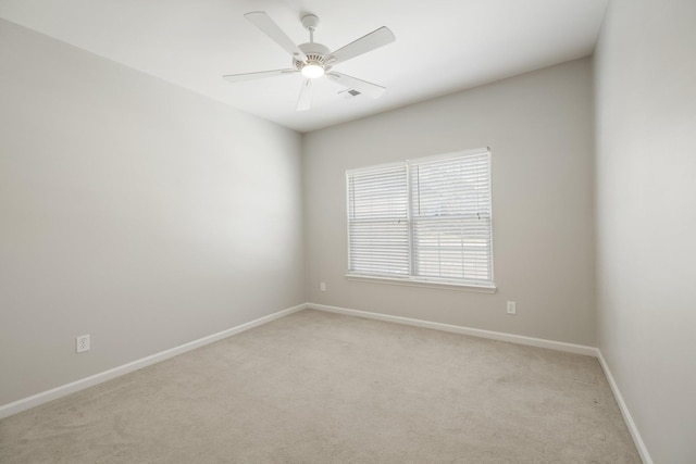 unfurnished room featuring ceiling fan and light colored carpet