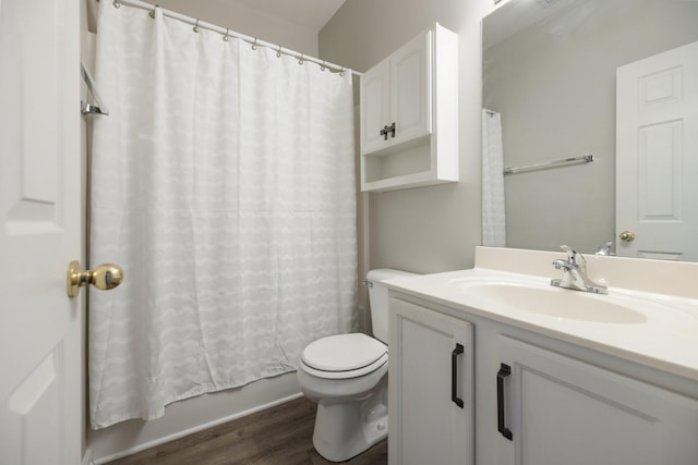 full bathroom with shower / tub combo, vanity, hardwood / wood-style flooring, and toilet