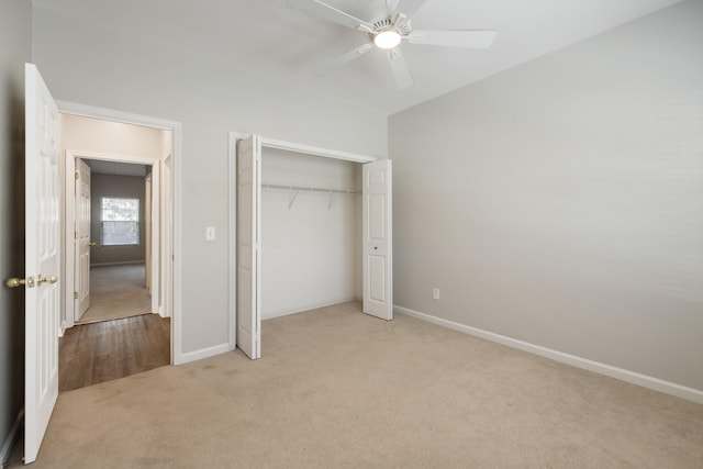 unfurnished bedroom featuring ceiling fan, light carpet, and a closet