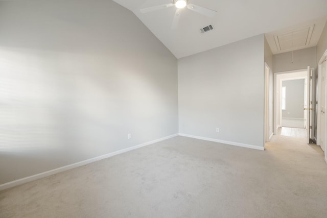 carpeted empty room featuring ceiling fan and vaulted ceiling