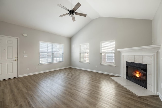 unfurnished living room featuring ceiling fan, lofted ceiling, a fireplace, and light hardwood / wood-style flooring