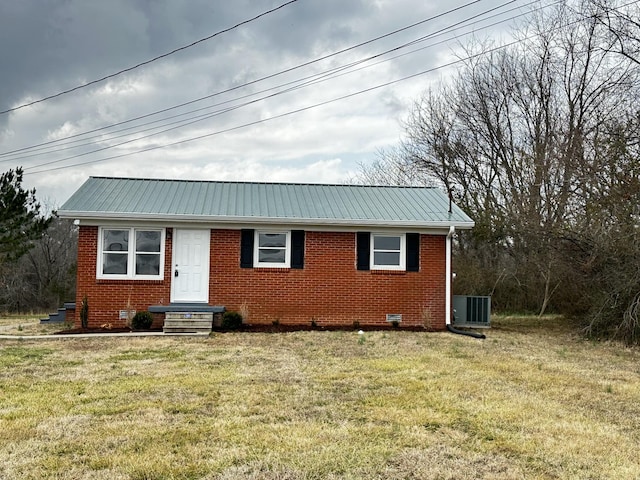 view of front facade with central AC and a front lawn