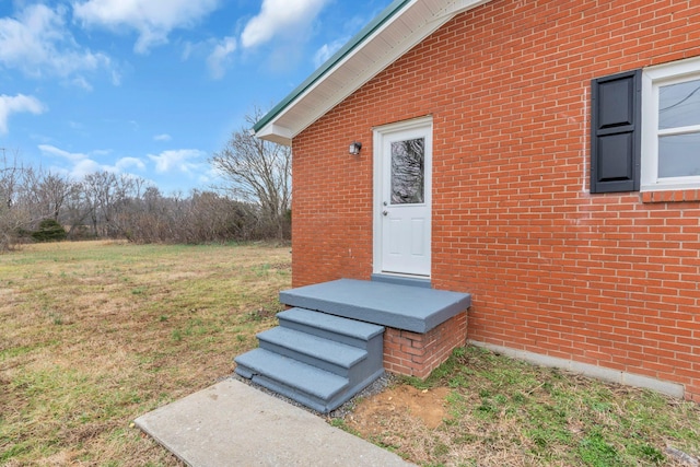 doorway to property with a yard