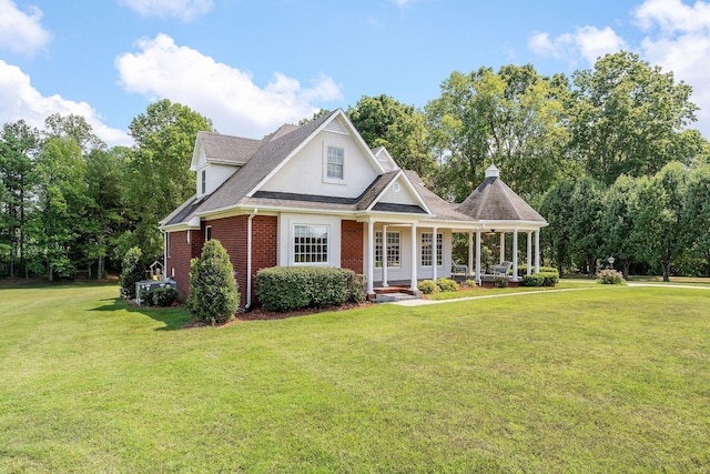 view of front of property featuring covered porch and a front yard