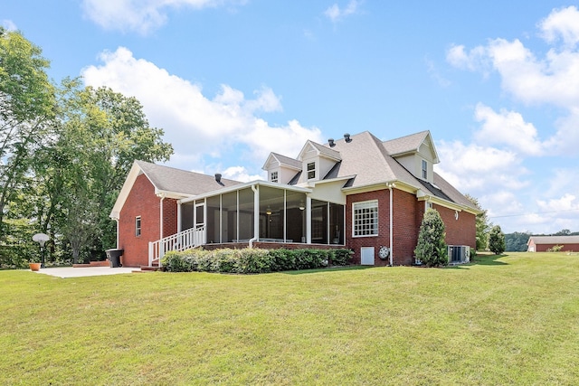 back of house featuring a sunroom, a yard, cooling unit, and a patio