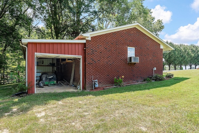 view of side of property with an outbuilding, cooling unit, and a lawn