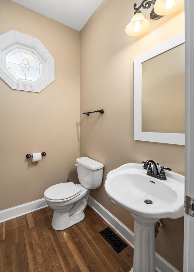 bathroom featuring toilet and hardwood / wood-style flooring