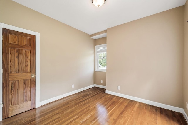 unfurnished room featuring hardwood / wood-style flooring