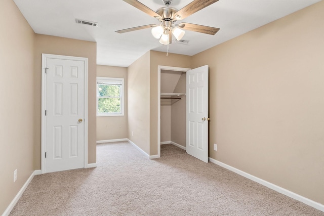 unfurnished bedroom with ceiling fan and light colored carpet