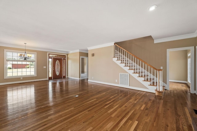 unfurnished living room with crown molding, dark wood-type flooring, and a notable chandelier