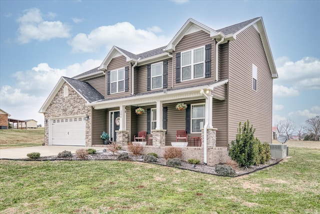 craftsman-style home with a porch, a garage, and a front yard