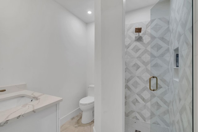 bathroom featuring vanity, toilet, and a shower with door