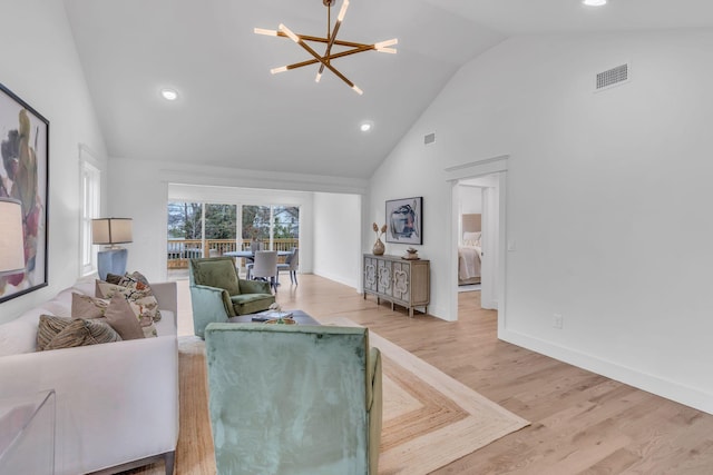 living room with vaulted ceiling, wood-type flooring, and a chandelier