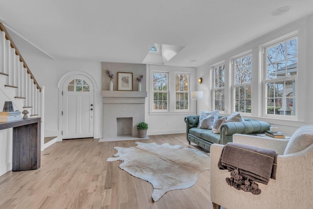 living room featuring plenty of natural light and light hardwood / wood-style floors