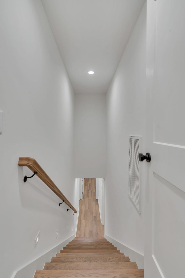 stairs with hardwood / wood-style flooring