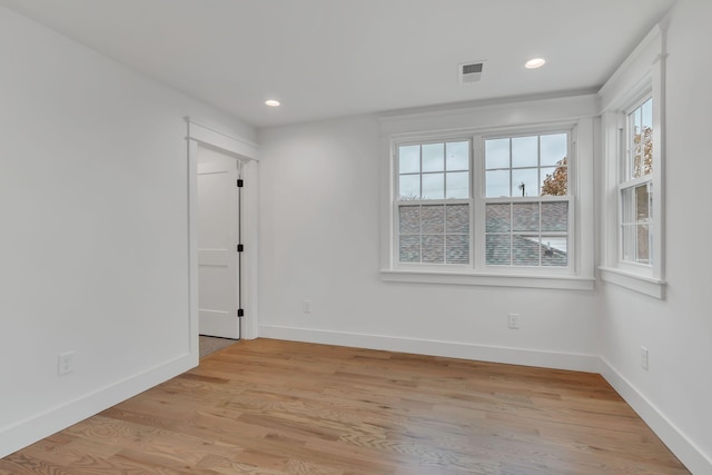 empty room featuring plenty of natural light and light hardwood / wood-style floors