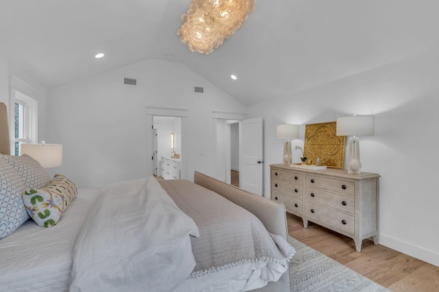 bedroom featuring light hardwood / wood-style flooring and vaulted ceiling