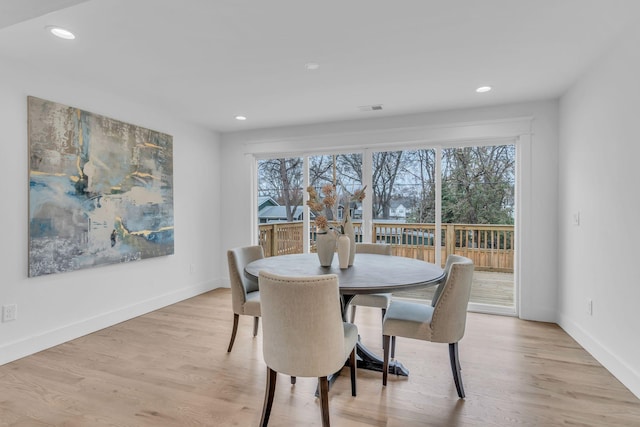 dining space with light hardwood / wood-style floors