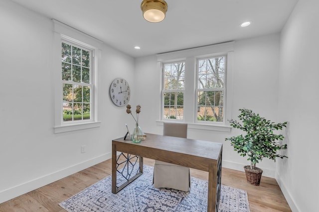 home office with a healthy amount of sunlight and light wood-type flooring