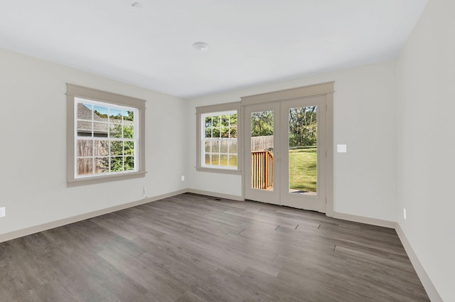 unfurnished room featuring dark hardwood / wood-style flooring and french doors