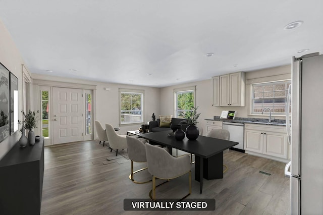 dining area featuring sink and dark hardwood / wood-style floors