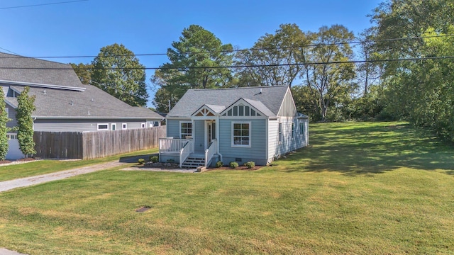 view of front of property with a front lawn and an outdoor structure