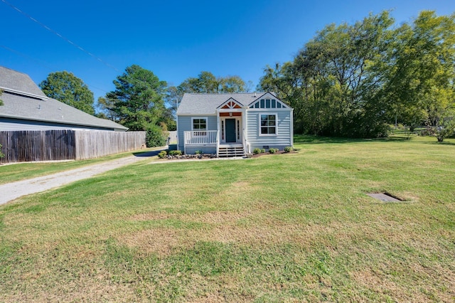 view of front of property with a porch and a front yard