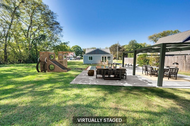 view of yard with an outbuilding, a playground, and a patio