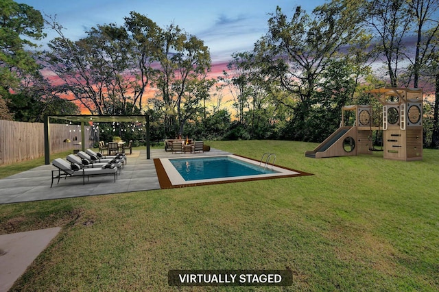 pool at dusk featuring a yard, an outdoor hangout area, a playground, and a patio area