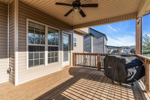 wooden deck featuring area for grilling and ceiling fan