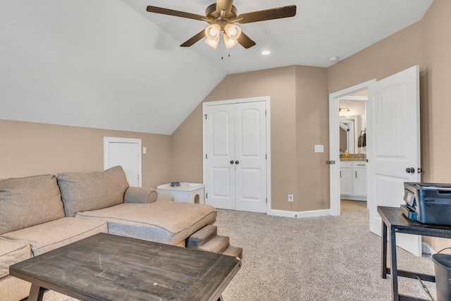 carpeted living room featuring ceiling fan and lofted ceiling