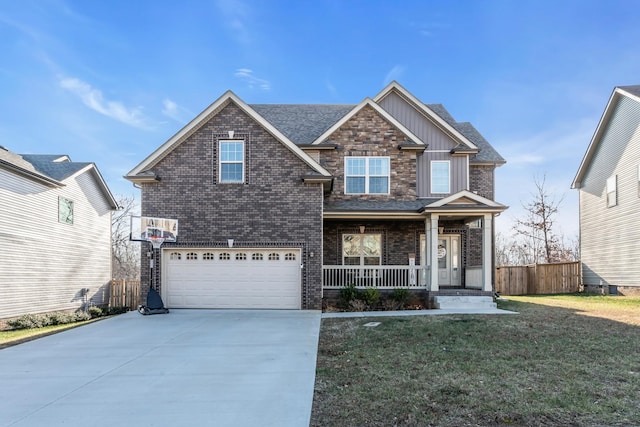 view of front of property featuring a front lawn, a porch, and a garage