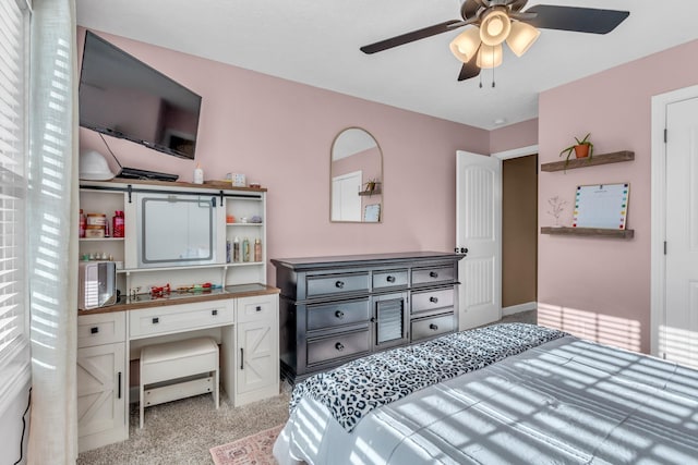 bedroom featuring light carpet and ceiling fan