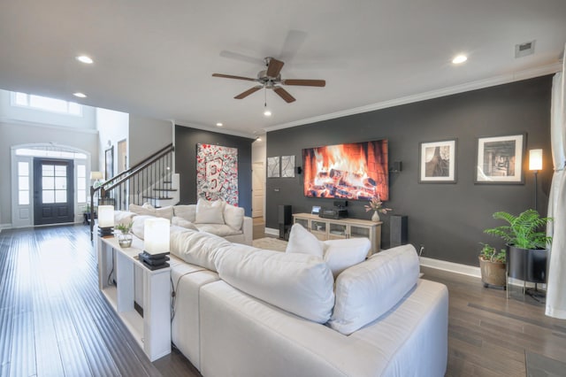 living room with crown molding, ceiling fan, and dark hardwood / wood-style flooring