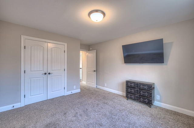 unfurnished bedroom with a closet and carpet