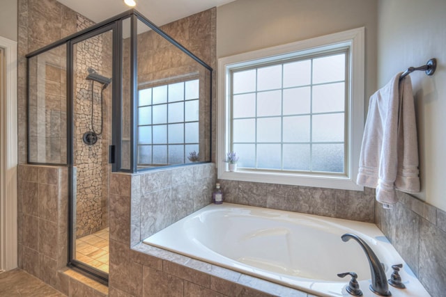 bathroom featuring shower with separate bathtub