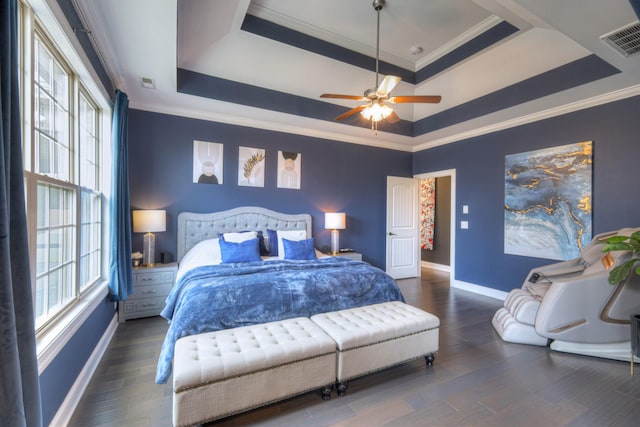 bedroom with ceiling fan, ornamental molding, dark hardwood / wood-style floors, and a raised ceiling