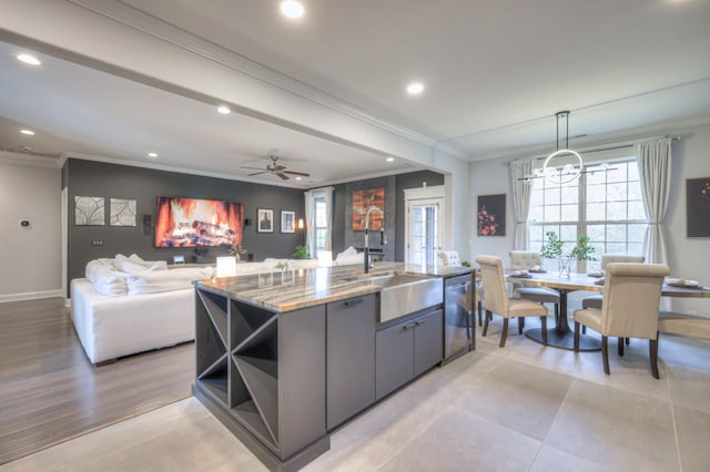 kitchen with crown molding, sink, decorative light fixtures, and dishwasher