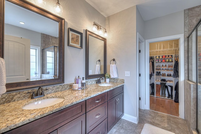 bathroom featuring vanity and a shower with shower door