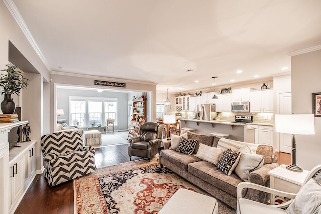 living room with an inviting chandelier, dark hardwood / wood-style floors, and ornamental molding