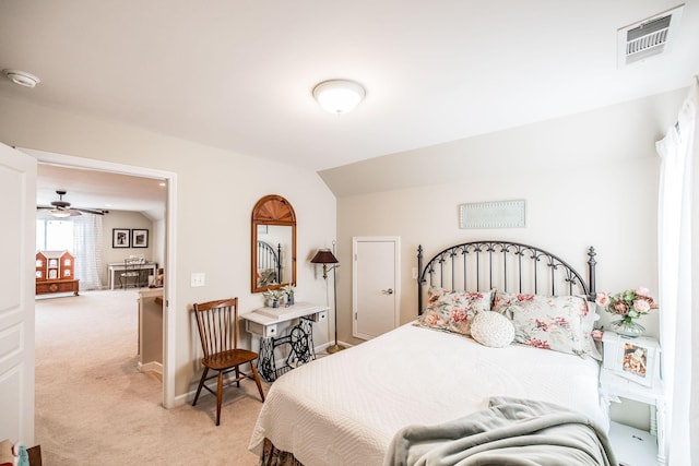 bedroom with light colored carpet and vaulted ceiling