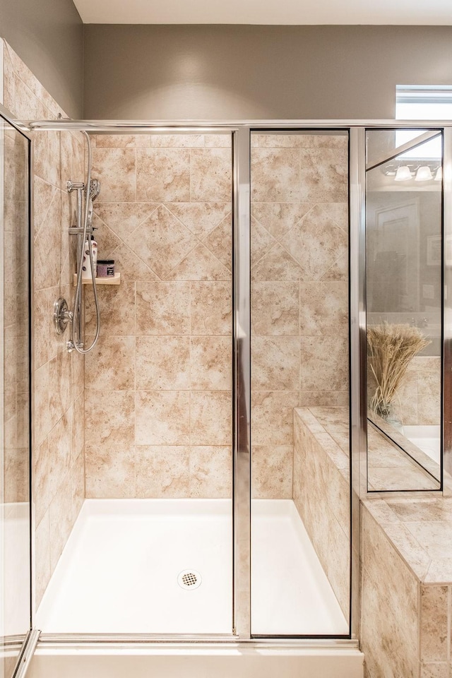 bathroom featuring a shower with door