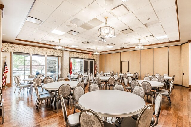 dining space featuring a raised ceiling and hardwood / wood-style floors