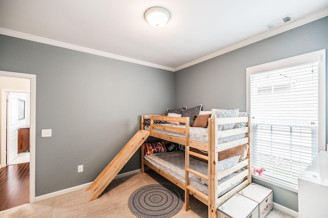 carpeted bedroom featuring ornamental molding