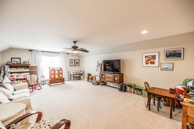 carpeted living room with ceiling fan and lofted ceiling